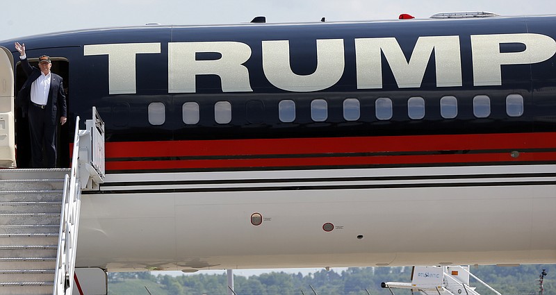 
              Republican presidential candidate Donald Trump waves as he arrives on his plane before he speaks at a campaign rally, Saturday, June 11, 2016 at a private hanger at Greater Pittsburgh International Airport in Moon, Pa. (AP Photo/Keith Srakocic)
            