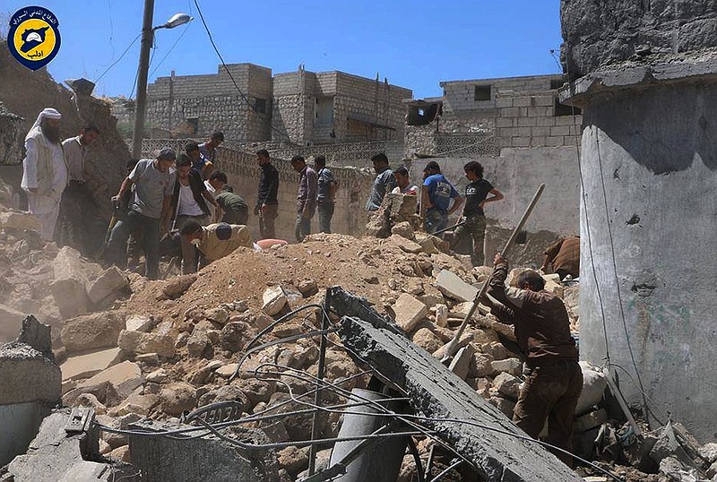 
              This photo provided by the Syrian Civil Defence White Helmets, which has been authenticated based on its contents and other AP reporting, shows Civil Defense workers and Syrian citizens inspect damage buildings after airstrikes hit a market area in Idlib, Syria, Sunday, June. 12, 2016. Anti-government activists said that airstrikes have hit a market and other targets in the northwestern Syrian city of Idlib, killing at least 12 people. (Syrian Civil Defence White Helmets via AP)
            