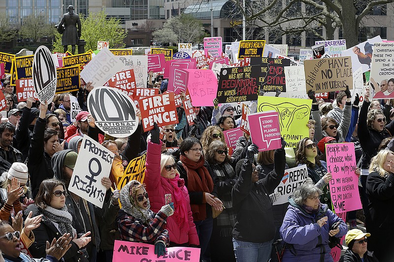 
              In this April 9, 2016 file photo,  hundreds of abortion rights supporters gather at the Indiana Statehouse in Indianapolis to protest an anti-abortion law signed by Gov. Mike Pence, that is among the most restrictive in the U.S. A federal judge weighing whether to block a new Indiana law mandating that aborted fetuses be buried or cremated and also banning abortions sought because of a fetus' genetic abnormalities will hear Tuesday, June 14, 2016,  from attorneys for the measure's supporters and opponents. (Mykal McEldowney/The Indianapolis Star via AP) NO SALES; MANDATORY CREDIT
            