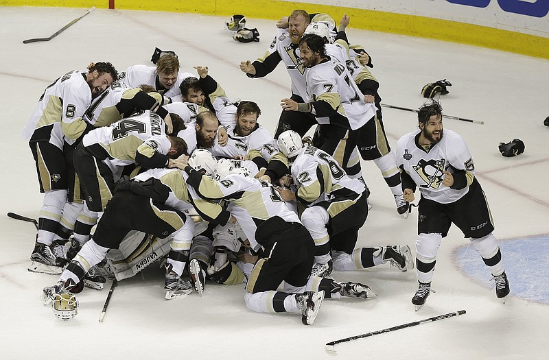 Pittsburgh Penguins players celebrate after beating the San Jose Sharks in Game 6 of the NHL hockey Stanley Cup Finals in San Jose, Calif., Sunday, June 12, 2016. The Penguins won 3-1 to win the series 4-2. (AP Photo/Eric Risberg)