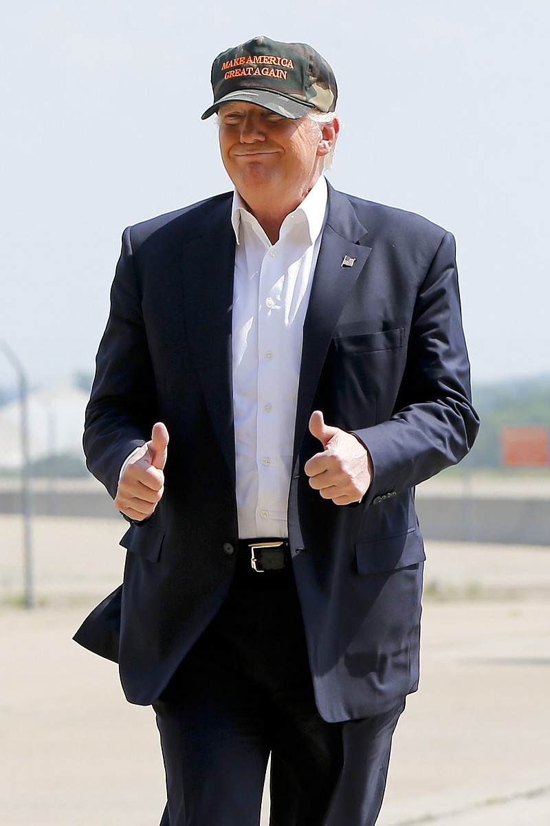 
              Republican presidential candidate Donald Trump gives a thumbs up as he arrives for a campaign rally, Saturday, June 11, 2016, at a private hanger at Greater Pittsburgh International Airport in Moon, Pa. (AP Photo/Keith Srakocic)
            