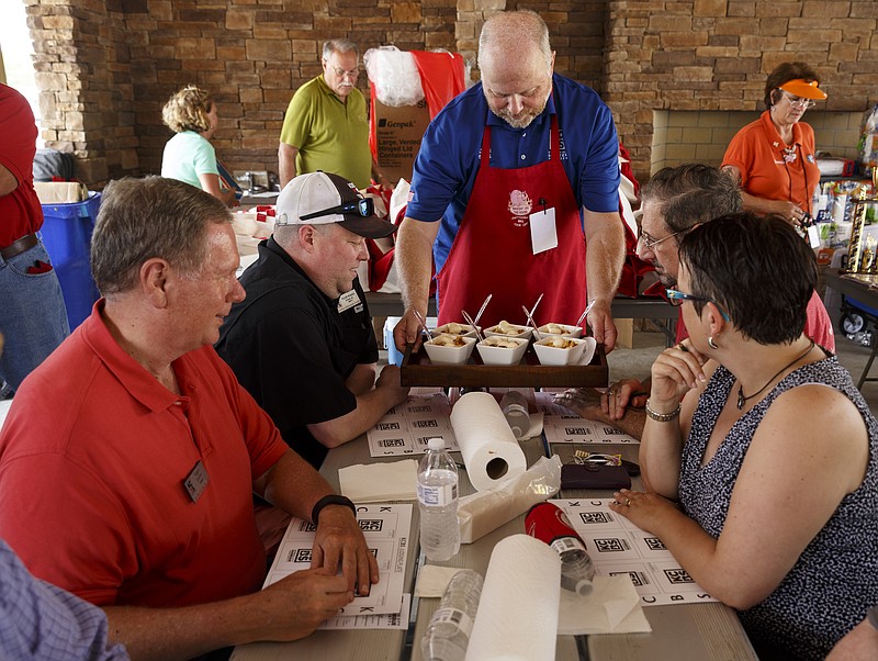 David Stone shows a dessert entry to judges for presentation judging June 4 at the Fire in the Valley Red Bank BBQ festival, which was moved to Camp Jordan Park in East Ridge, Tenn., because of space concerns.