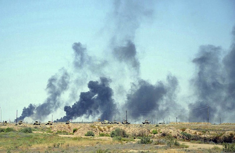 
              Smoke rises after airstrikes by U.S.-led coalition warplanes as Iraqi security forces advance their positions in the southern neighborhoods of Fallujah to retake the city from Islamic State militants, Iraq, Sunday, June 12, 2016. (AP Photo/Osama Sami)
            