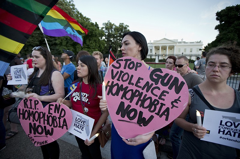 
              Rachel Henry, from left, Selene Arciga, Nicolette Gullickson, Joanna Lamstein join members and supporters of the LGBT as they gather for a candlelight vigil in front of the White House in Washington, Sunday, June 12, 2016, in support for the victims and their families and friends, who were killed and injured in a massacre at an Orlando nightclub. (AP Photo/Manuel Balce Ceneta)
            