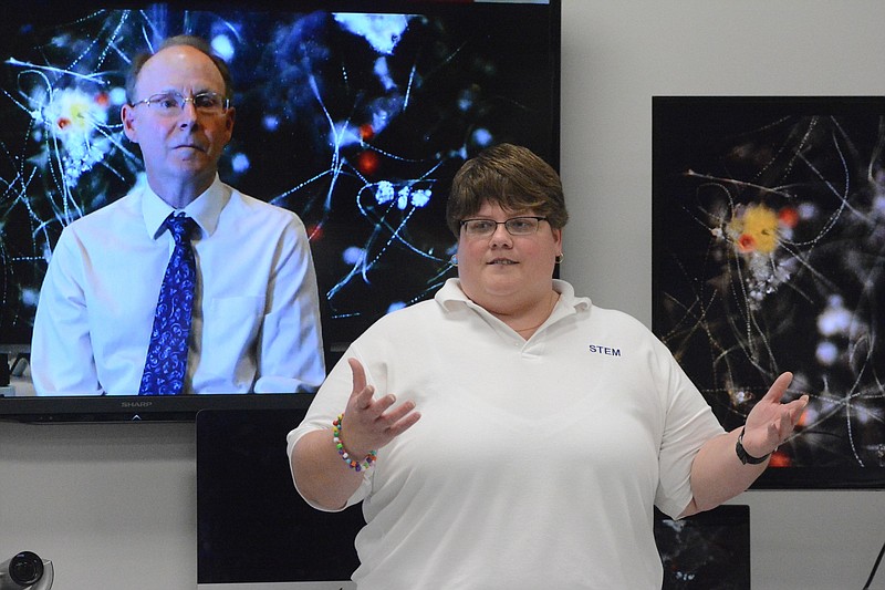 Shannon Seigle, a biology teacher at the STEM School on the Chattanooga State campus, speaks Thursday, May 14,  2015, in Chattanooga, Tenn. On the screen behind her via video hookup is Richard Weinberg, a research associate professor at the University of California School of Cinematic Arts.