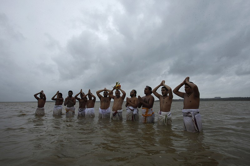 
              FILE- In this July 16, 2013 file photo, Hindu priests offer prayers to Varuna, the Hindu god of rain as they pray for rains standing in the waters at the Osman Sagar Lake on the outskirts of Hyderabad, India.The seasonal monsoon, which hits the region between June and September, delivers more than 70 percent of India's annual rainfall. Its arrival is eagerly awaited by hundreds of millions of subsistence farmers across the country, and delays can ruin crops or exacerbate drought.In an effort to better understand and predict South Asia's seasonal monsoon, British scientists are getting ready to release robots into the Bay of Bengal in a study of how ocean conditions might affect rainfall patterns. (AP Photo/Mahesh Kumar A, File)
            