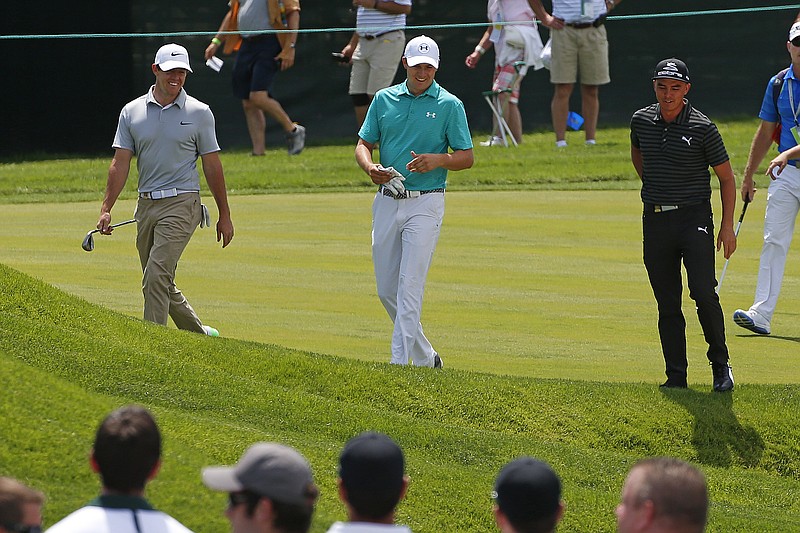 
              Defending U.S. Open Champion Jordan Spieth, center, walks up the 17th fairway with Rory McIlroy, left, of Northern Ireland, and Rickie Fowler during a practice round for the 2016 US Open golf championship at Oakmont Country Club in Oakmont, Pa., Monday, June 13, 2016. (AP Photo/Gene J. Puskar)
            