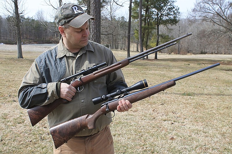 John Fink of the Remington Arms Company displays new and old models of .22 rifles. Being part of the hunting, gun and outdoors world as a writer can be rewarding, but it has its challenges as well, writes outdoors columnist Larry Case.