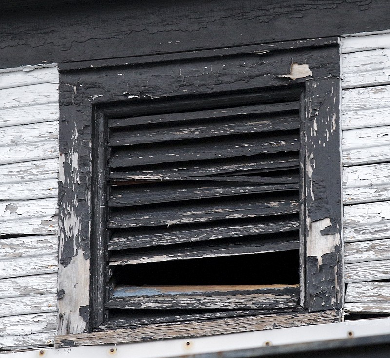 A broken ventilation window in the attic of an abandoned house in the Highland Park neighborhood of Chattanooga, Tenn., is seen Friday, March 13, 2015. In addition to identifying abandoned houses, Officer Gregory and community members have worked to identify and correct blight.