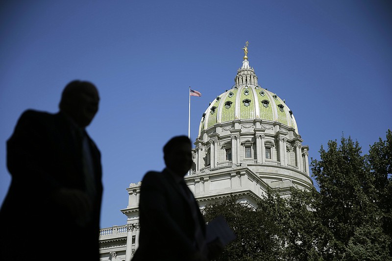 
              ADVANCE FOR USE ON THURSDAY, JUNE 16, AND THEREAFTER - In this Oct. 7, 2015 photo, people walk past the Pennsylvania Capitol building in Harrisburg, Pa. Truly diverse legislatures are rarity across the United States; while minorities have made some political gains, they remain severely underrepresented in Congress and nearly every state legislature, according to an analysis of demographic data by The Associated Press. (AP Photo/Matt Rourke)
            
