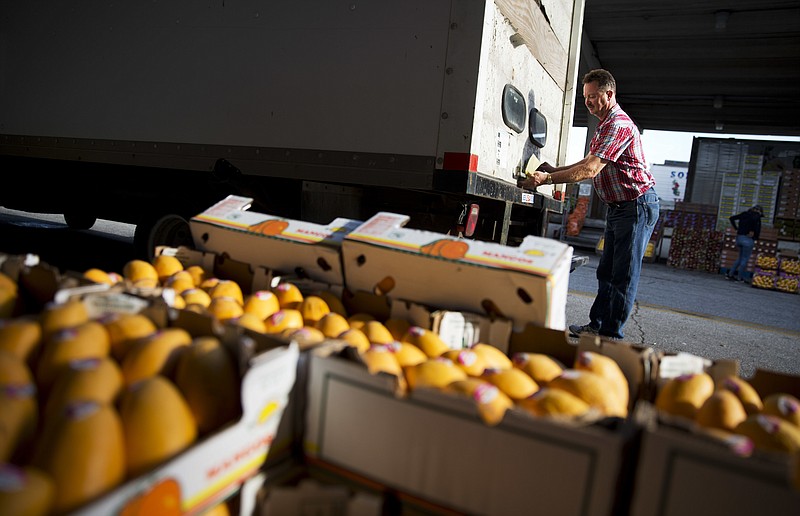 
              FILE - In this Saturday, June 6, 2015, file photo, Michael Gipson, of Tracy City, Tenn., closes the door to his truck after loading up produce at the Atlanta Farmers Market in Atlanta. On Wednesday, June 15, 2016, the Labor Department reports on U.S. producer price inflation in May. (AP Photo/David Goldman, File)
            