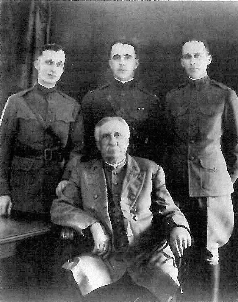 Jonathan Bachman, seated, with his three grandsons.