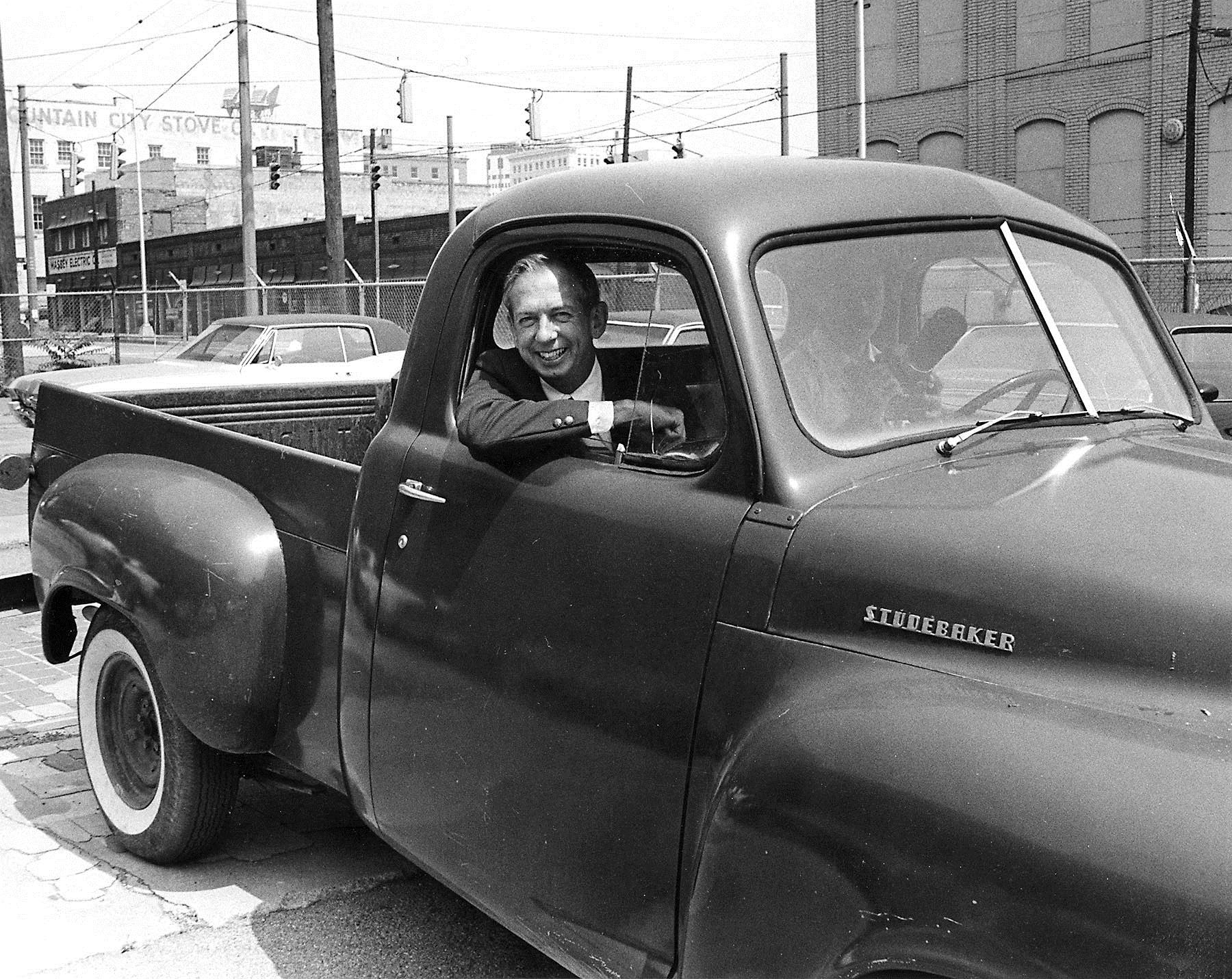Editor Lee Anderson leans from the window of photographer Jim Martin's Studebaker pickup truck in this 1975 photo.