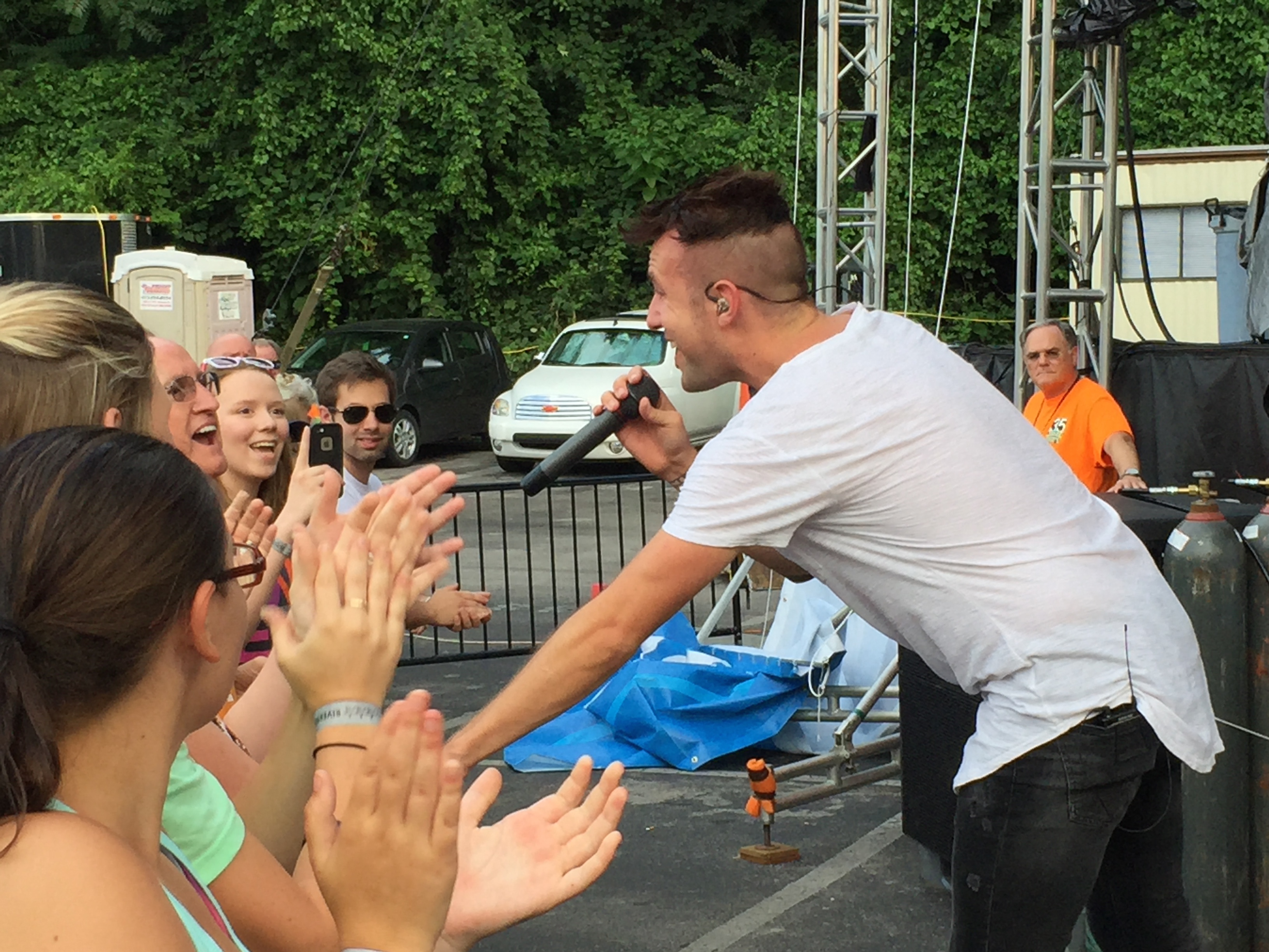 Jonathan Steingard, the lead singer of Christian pop/punk band Hawk Nelson, stands on the newly installed barricade at the Bud Light Stage during the band's performance on Tuesday. The barricade was added this year to prevent overcrowding injuring those standing at the foot of the stage.