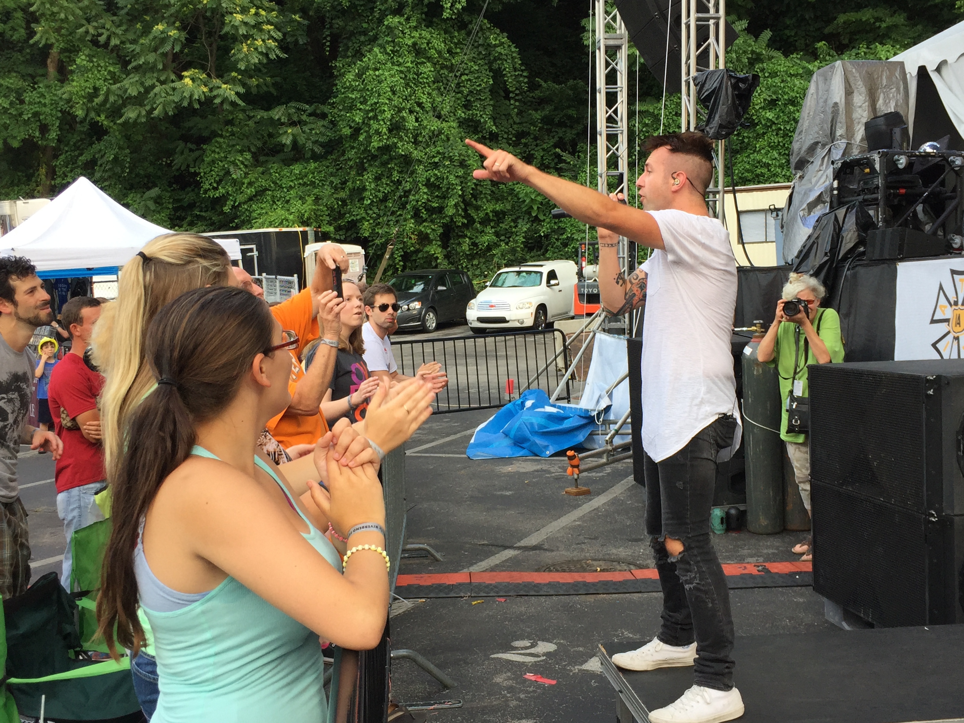 Jonathan Steingard, the lead singer of Christian pop/punk band Hawk Nelson, stands on the newly installed barricade at the Bud Light Stage during the band's performance on Tuesday. The barricade was added this year to prevent overcrowding injuring those standing at the foot of the stage.
