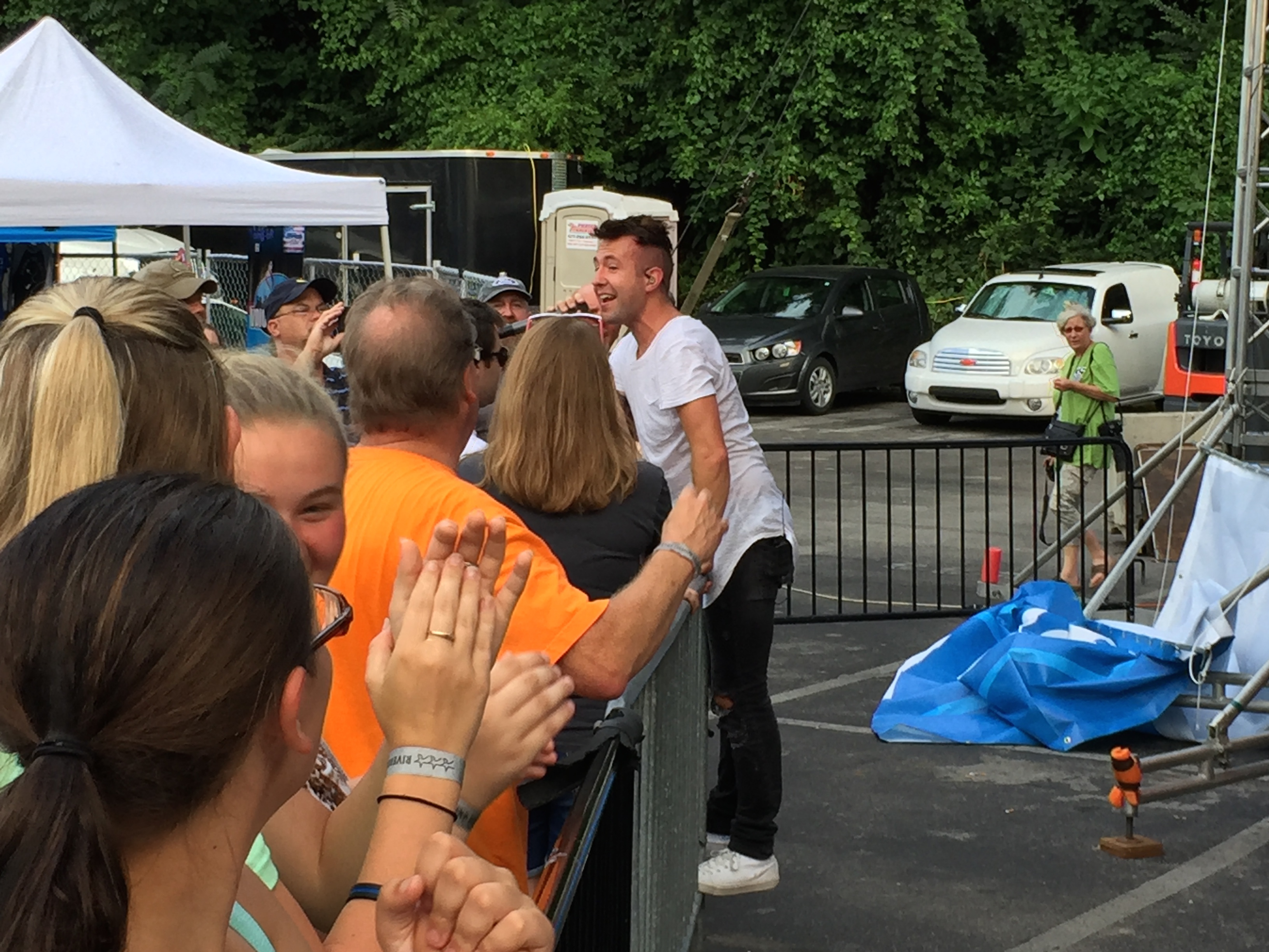 Jonathan Steingard, the lead singer of Christian pop/punk band Hawk Nelson, stands on the newly installed barricade at the Bud Light Stage during the band's performance on Tuesday. The barricade was added this year to prevent overcrowding injuring those standing at the foot of the stage.