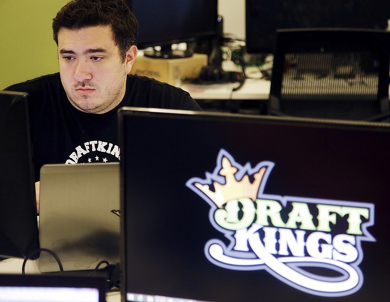Len Don Diego, marketing manager for content at DraftKings, works at his station at the company's offices in Boston this past September. DraftKings and FanDuel are downplaying media reports this week that the two biggest daily fantasy sports companies could team up, but given their swift change of fortune over the past year, industry watchers say the timing's right for a deal.