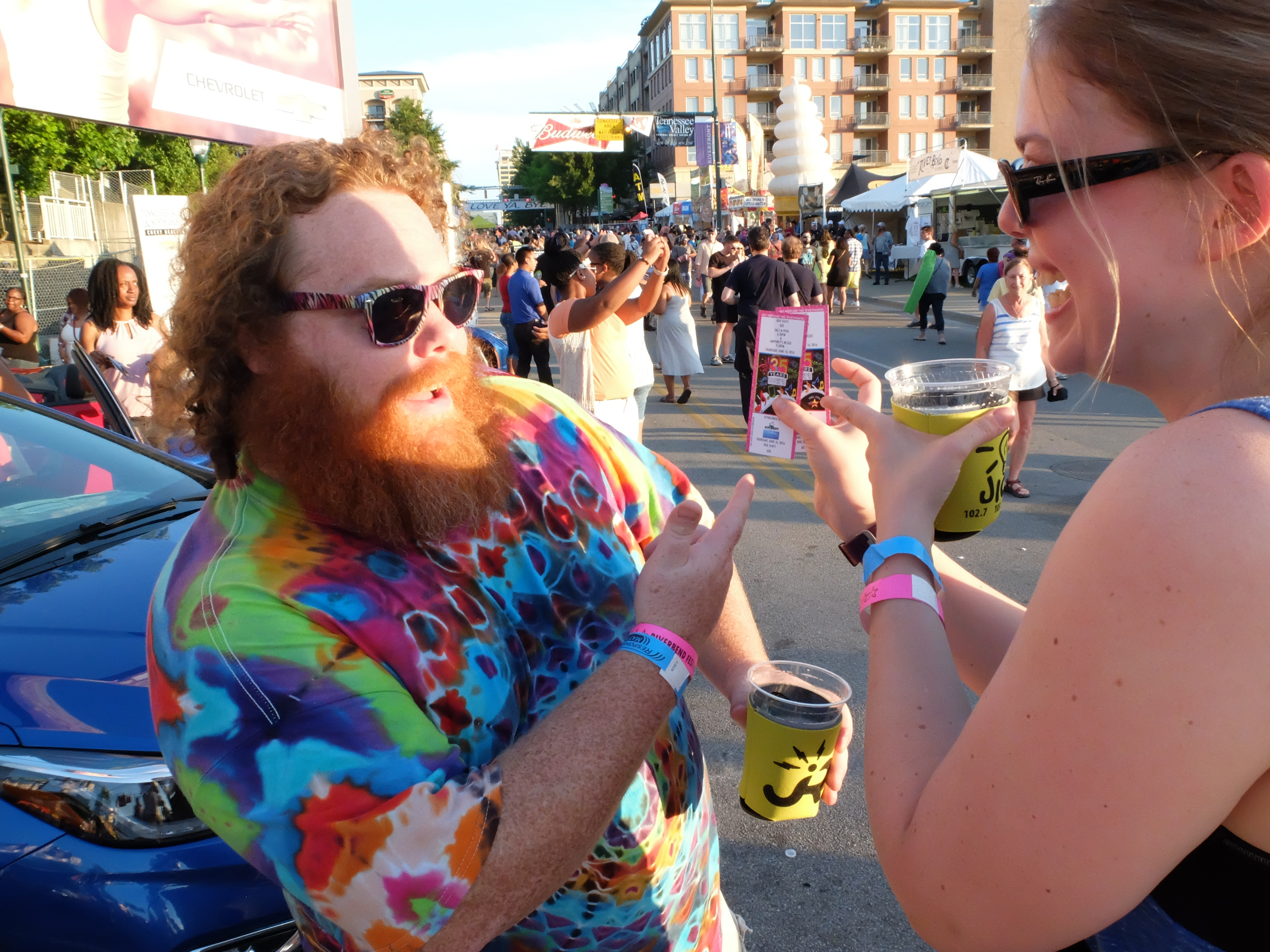 Richard Heller, left, gets excited as Lauren Heller holds two box seats they just won at the KZ 106 toss on the midway at Riverbend late Thursday.