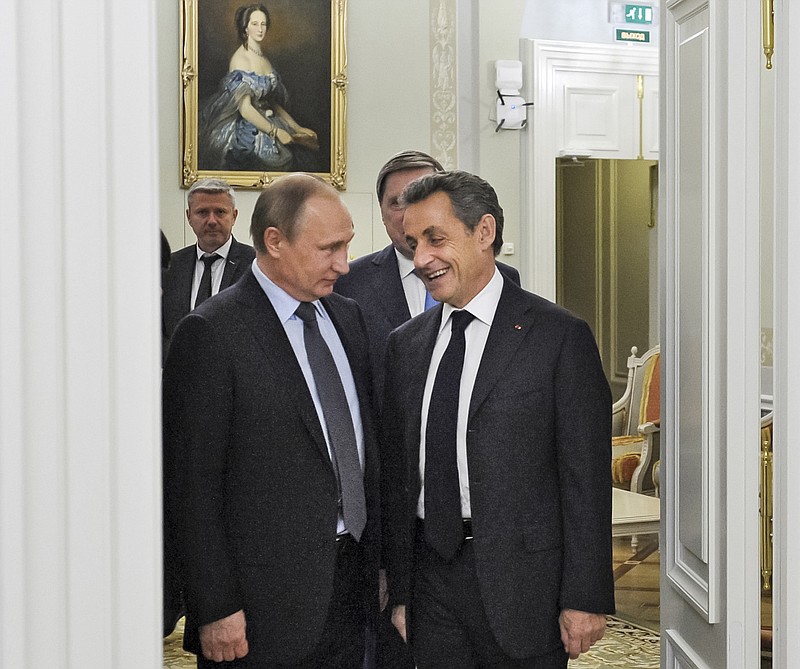 
              Russian President Vladimir Putin, left, and former French President Nicolas Sarkozy speak to each other during their meeting on the eve of the St. Petersburg International Investment Forum, in Russia, Wednesday, June 15, 2016. (Mikhail Klimentyev, Sputnik, Kremlin Pool Photo via AP)
            