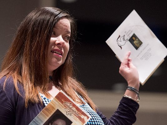 Brandy Mayo, of Nashville, holds up the funeral programs from four family members who died from addiction while speaking during The Tennessean's Opioid Epidemic Forum on Wednesday, June 15, 2016, at the First Amendment Center in Nashville.
(Photo: Andrew Nelles / The Tennessean)