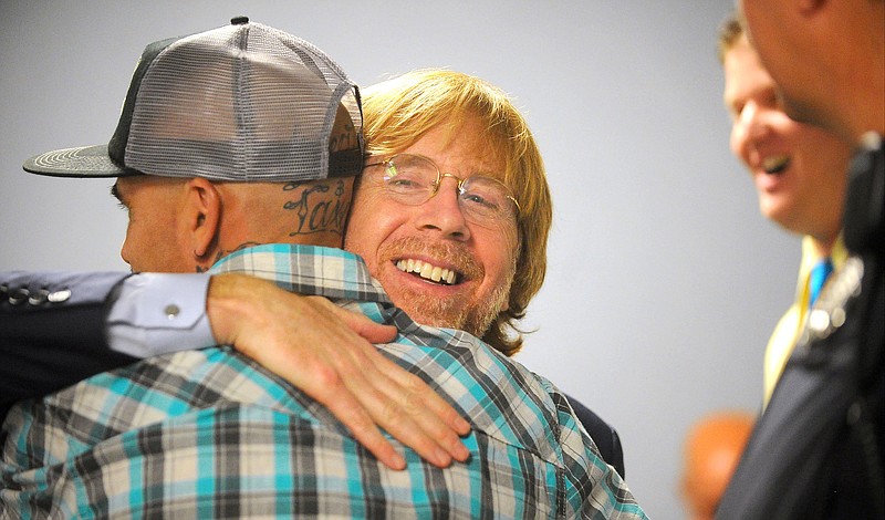 
              Lead singer of the national rock band, Phish, Trey Anastasio, hugs a graduate of a court drug rehabilitation program in Washington County Court in Ft. Edward, NY, Wednesday, June 15,2016.  Anastasio is a past graduate of the same program. He told five new drug court graduates and a packed courtroom that the program put him on the road to nearly a decade of sobriety and likely saved his life.  (Steve Jacobs/The Post-Star via AP)
            