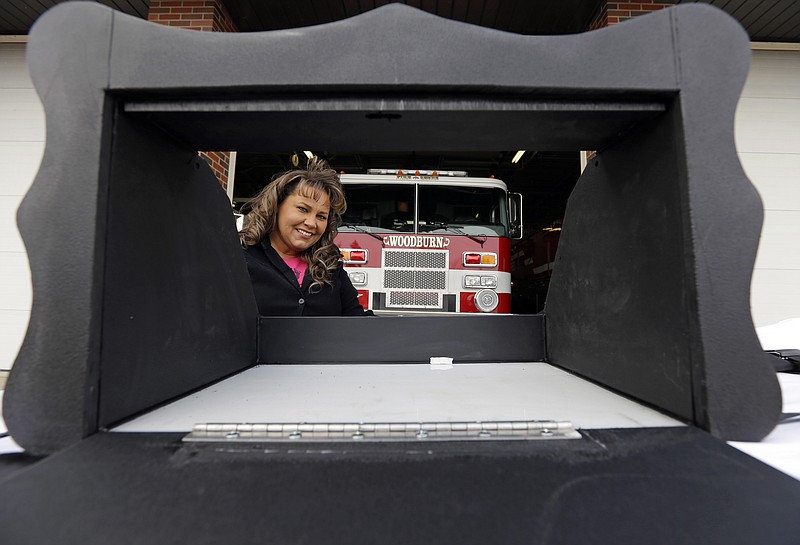 
              FILE - In this file photo taken on Thursday, Feb. 26, 2015, Monica Kelsey, firefighter and medic who is president of Safe Haven Baby Boxes Inc., poses with a prototype of a baby box, where parents could surrender their newborns anonymously, outside her fire station in Woodburn, Ind. Kelsey, founder of the organization, said she is undeterred by a warning from Indiana that they are illegal. (AP Photo/Michael Conroy, File)
            