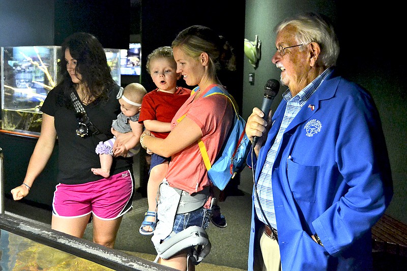Tennessee Aquarium docent Bill Sesko, right, tells visitors about the attraction's Sturgeon Encounter.  Sesko was recently recognized by Governor Bill Haslam for his contribution to tourism.  

 