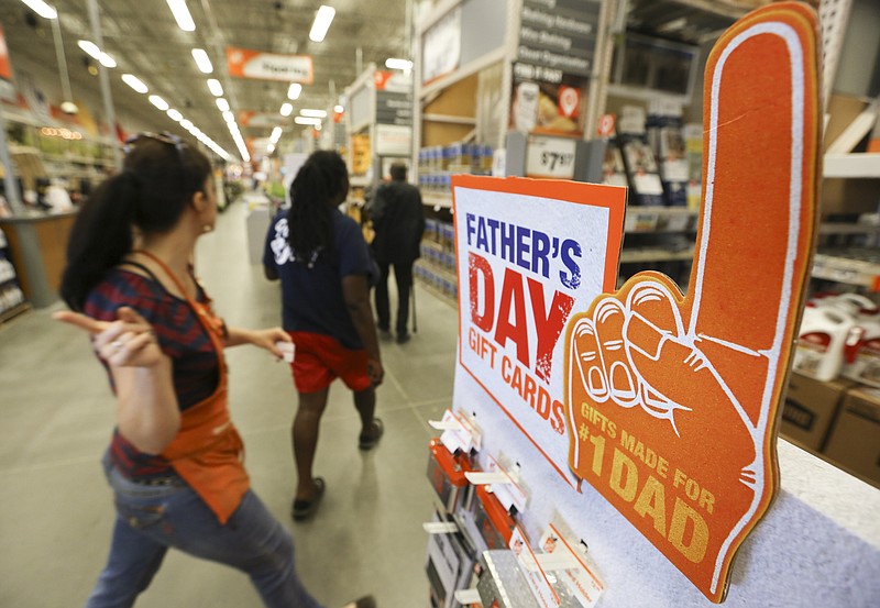 Staff Photo by Dan Henry / The Chattanooga Times Free Press- 6/17/16.  Connie Brandt,  Kitchen & Bath Designer with The Home Depot, assists a customer after speaking about tool and technology based Father's Day offerings that the East Brainerd home improvement store offers while working June 17, 2016.
