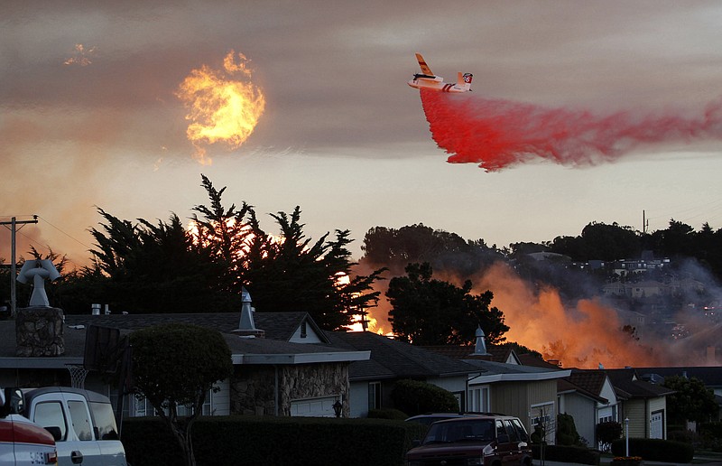 
              FILE - In this Sept. 9, 2010, file photo, a massive fire following a pipeline explosion roars through a mostly residential neighborhood in San Bruno, Calif. One of the country's largest utility companies is set to face a jury in a criminal trial accusing it of misleading investigators in the wake of a deadly pipeline explosion in the San Francisco Bay Area. The September 2010 blast of a Pacific Gas & Electric Co. natural gas pipeline sent a giant plume of fire into the air in a neighborhood in San Bruno, killing eight people and destroying 38 homes. Opening arguments in the trial began Thursday, June 16, 2016. (AP Photo/Jeff Chiu, File)
            