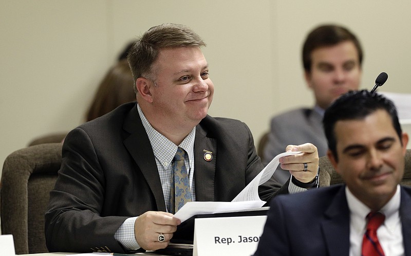 
              In this Thursday, June 9, 2016, photo, Rep. Jason Saine, R-Lincoln, smiles as lawmakers discuss charter schools during an Education K-12 House Standing Committee meeting at the Legislative Office Building in Raleigh, N.C. The North Carolina General Assembly is charging forward with a plan to hand over some of its lowest performing elementary schools to for-profit charter operators with aim of reversing dismal testing scores in over half the state's counties. (AP Photo/Gerry Broome)
            