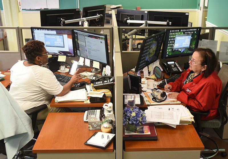 Sonya Shannon, left, and Sonia Sasse take calls Friday, June 17, 2016 at Chattanooga's 311 facility.