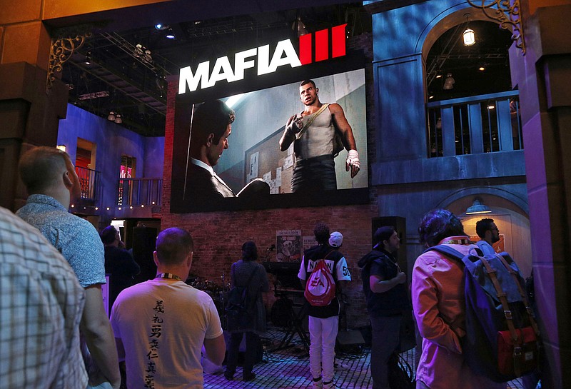 
              Gamers experience "Mafia III," an upcoming action-adventure video game developed by Hangar 13, at the Electronic Entertainment Expo in Los Angeles on Wednesday, June 15, 2016. (AP Photo/Nick Ut)
            