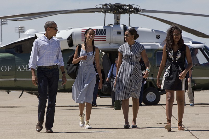 President Barack Obama, Malia Obama, first lady Michelle Obama, and Sasha Obama walk to board Air Force One after leaving Yosemite National Park via helicopter, on Sunday, June 19, 2016, after visiting the park to celebrate the 100th anniversary of the creation of America's national park system.(AP Photo/Jacquelyn Martin)