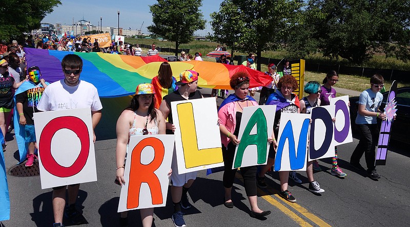 
              A youth group from ACR Health carry letters to commemorate the mass shooting in Orlando, Fla., during the Gay Pride Parade in Syracuse, N.Y., Saturday, June 18, 2016. Thousands of people have attended a lesbian, gay, bisexual and transgender pride parade and festival in upstate New York, less than a week after a deadly attack at a gay nightclub in Orlando. (Michael Greenlar/The Syracuse Newspapers via AP) MANDATORY CREDIT
            