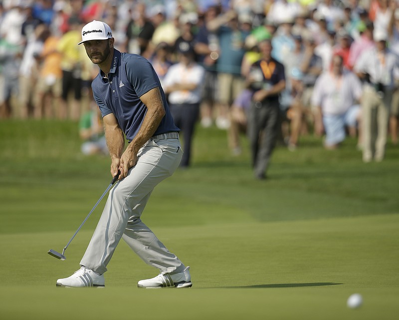 Dustin Johnson watches his putt on the seventh hole during the final round of the U.S. Open golf championship at Oakmont Country Club on Sunday, June 19, 2016, in Oakmont, Pa. (AP Photo/John Minchillo)
