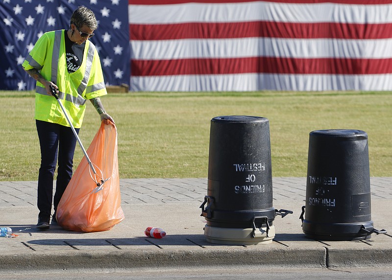 Staff Photo by Dan Henry / The Chattanooga Times Free Press- 6/20/16. Monique Due performs community service by picking up trash along the Chattanooga riverfront on Monday, June 20, 2016, from the past week's Riverbend Music Festival. 