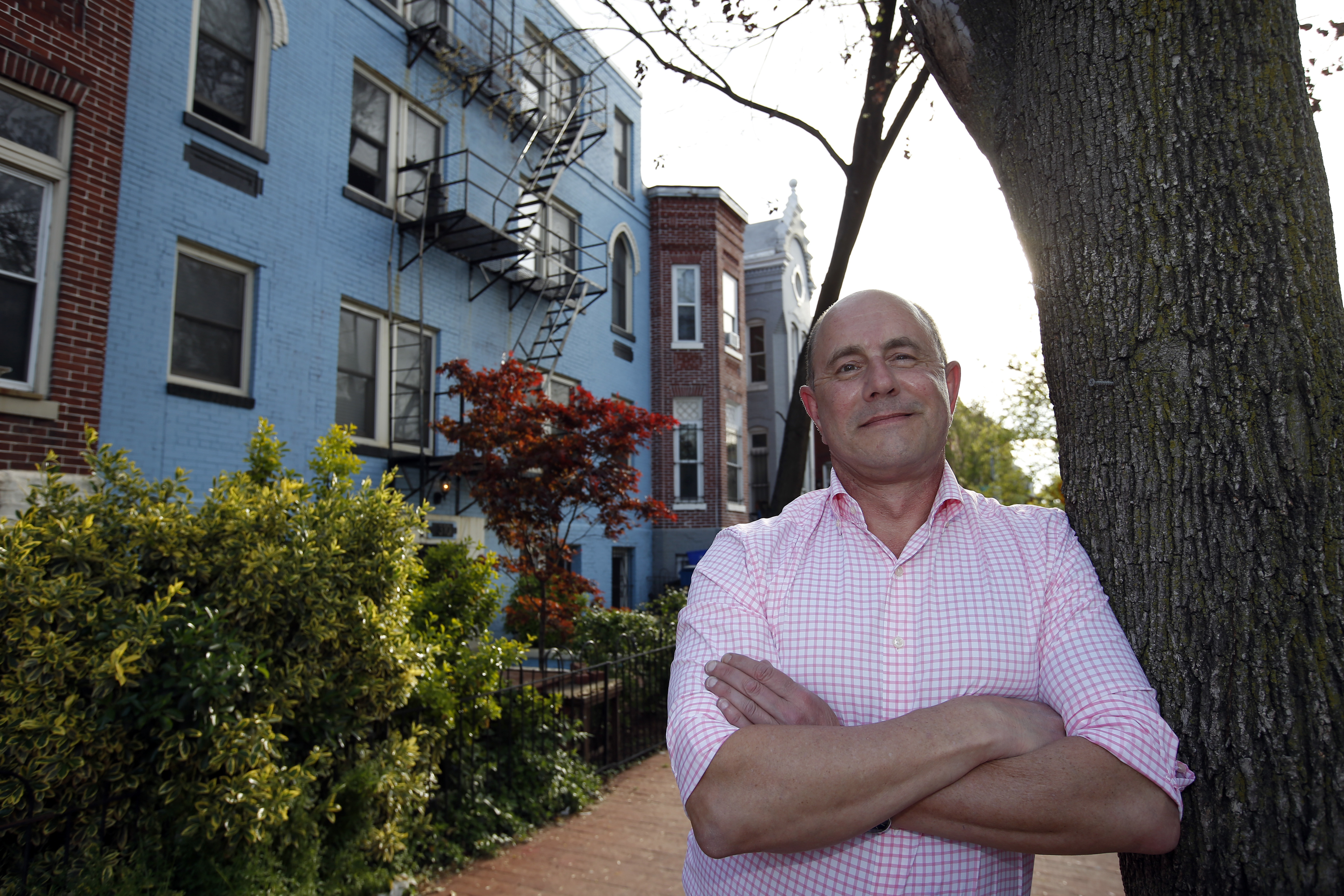 In this Tuesday, April 19, 2016, photo, Jim Phillips poses for a picture in front of the building in which he owns and rents out one of the units, in Washington. Phillips owns three properties, two of which he rents at a monthly positive cash flow of $300 to $400 relative to his ownership expenses. (AP Photo/Alex Brandon)