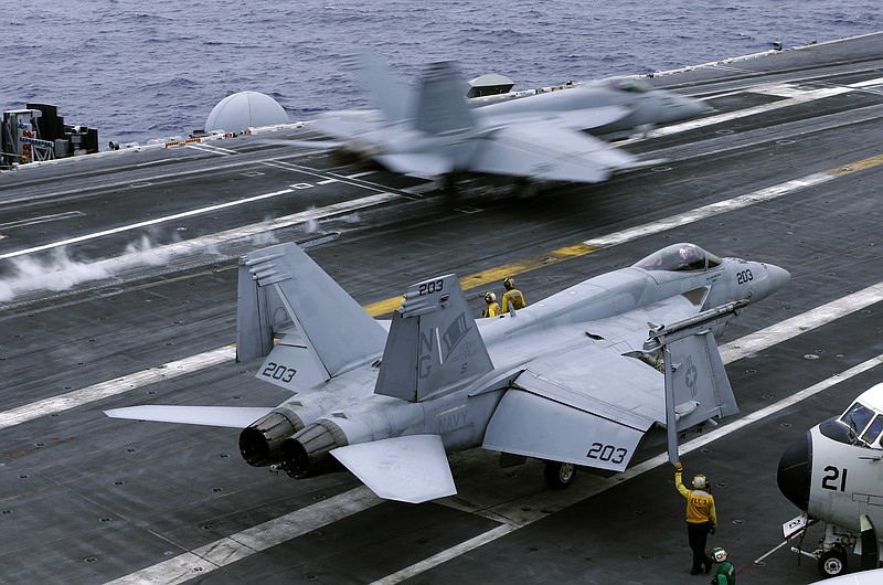 
              FILE - In this file photo from Wednesday, June 15, 2016, an F/A-18 Hornet takes off the deck of the nuclear-powered aircraft carrier the USS John C. Stennis during joint military exercise between the United States, Japan and India off the coast 180 miles east of Japan's southernmost island of Okinawa. The U.S. says at least one Chinese ship tailed the USS John C. Stennis daily during its recent cruise through the South China Sea, although no hostile incidents were reported. (AP Photo/Shizuo Kambayashi, File)
            