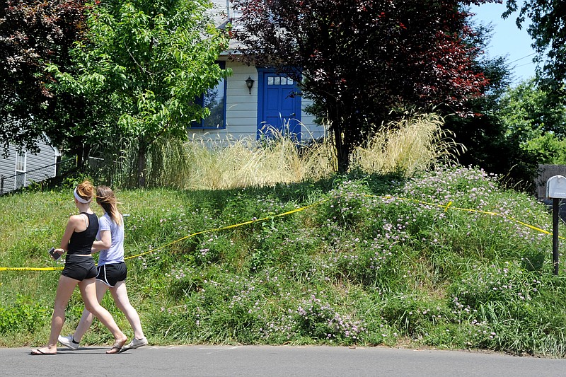 
              In this Saturday, June 19, 2016 photo, two women walk past the home of Lee Kaplan in Feasterville, Pa. Kaplan is accused of sexually assaulting a teenager whose parents gave her to him, according to police. Officials acting on a tip Thursday found Kaplan at his home along with numerous girls, ranging in age from 6 months to 18 years. (Tom Gralish/The Philadelphia Inquirer via AP)  PHIX OUT; TV OUT; MAGS OUT; NEWARK OUT; MANDATORY CREDIT
            