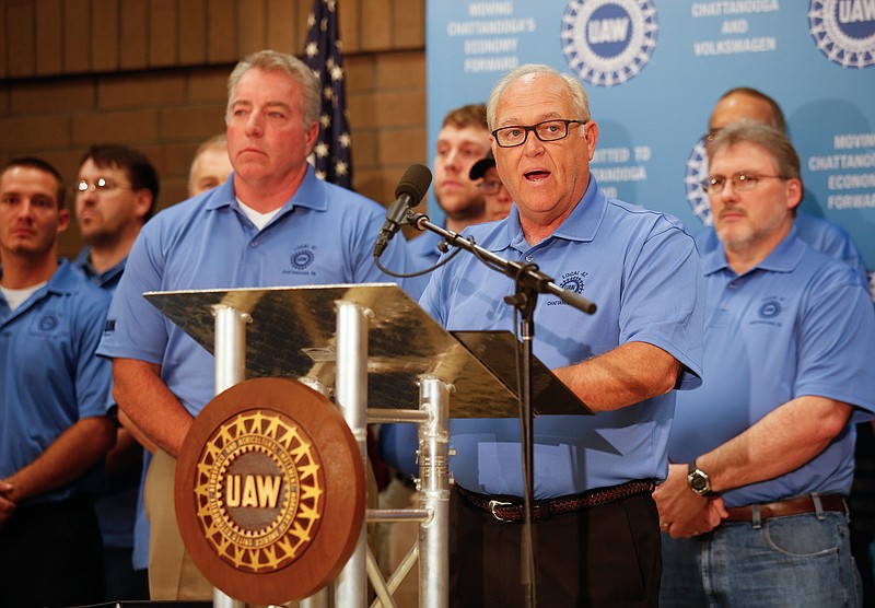 UAW President Dennis Williams stands with Volkswagen Chattanooga employees as he speaks during a news conference held Thursday, July 10, 2014, at the IBEW Local 175 in Chattanooga, Tenn., to announce the formation of a new local United Auto Workers' union in Chattanooga for Volkswagen workers.