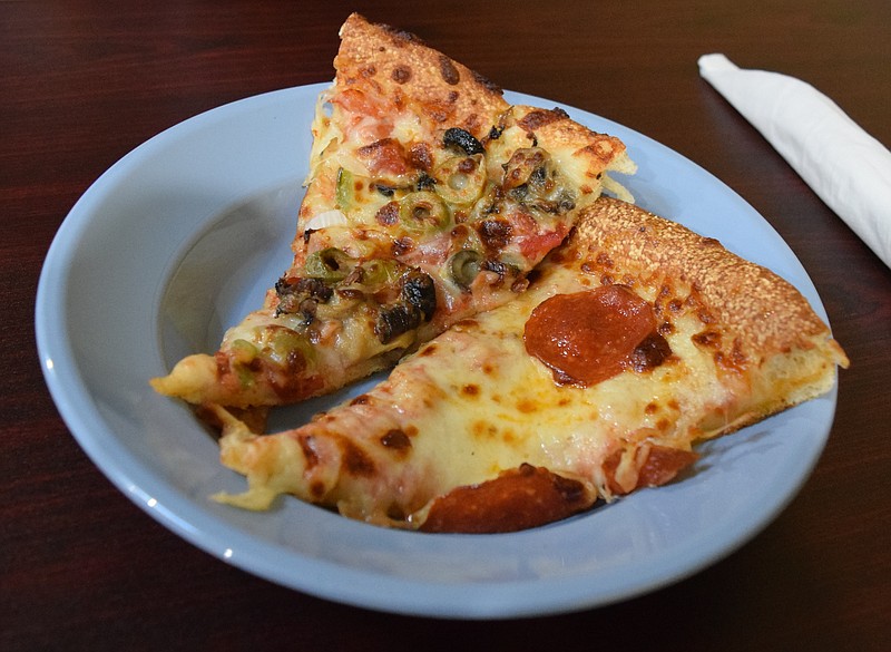 A slice of supreme pizza and a slice of pepperoni pizza from the hot food, salad and pizza bar.