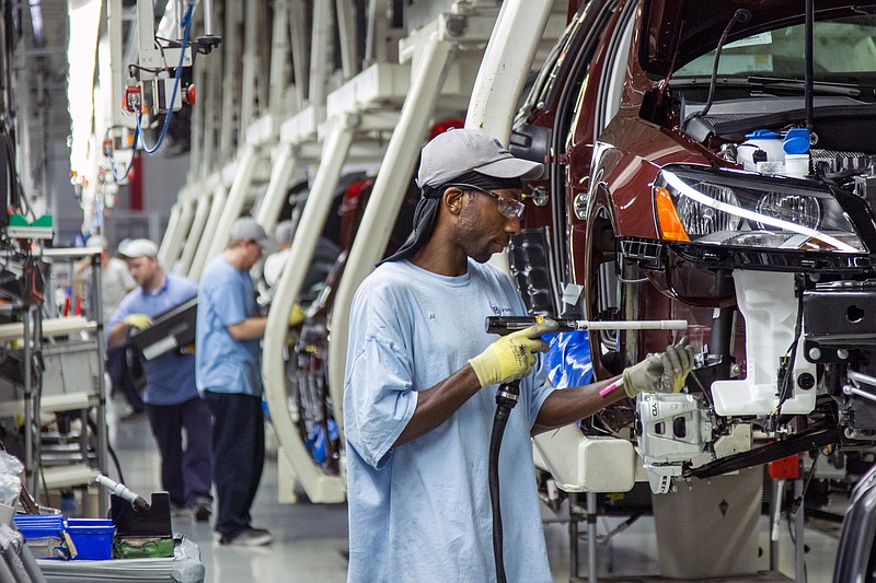 FILE - In this July 12, 2013, file photo, employees at the Volkswagen plant in Chattanooga, Tenn., work on the assembly of a Passat sedans. The United Auto Workers said on Tuesday, June 21, 2016, that Volkswagen reneged on an earlier agreement to recognize the union in exchange for the UAW dropping a legal challenge to the outcome of a union vote at the plant in 2014. (AP Photo/Erik Schelzig, File)