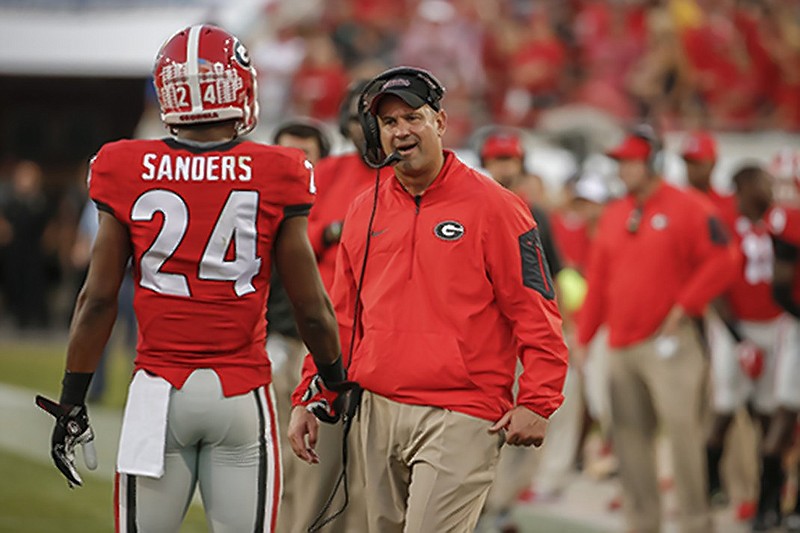 Georgia defensive coordinator Jeremy Pruitt talks to Georgia safety Dominick Sanders (24) during the second half of an NCAA college football game against Florida, Saturday, Oct. 31, 2015, in Jacksonville, Fla. Florida beat Georgia 27-3. (AP Photo/Stephen B. Morton)