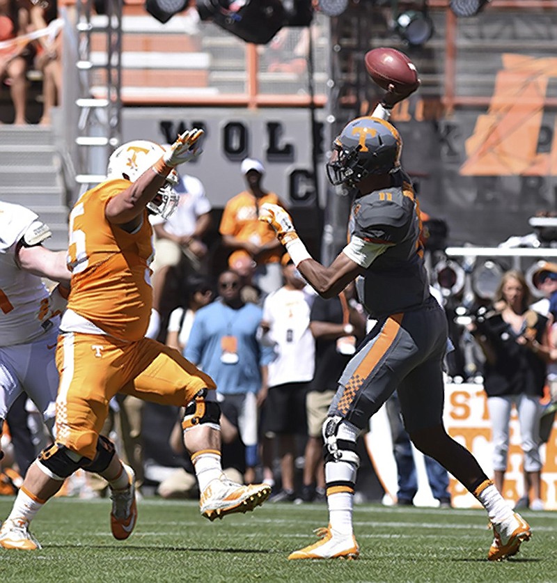 Quarterback Josh Dobbs (11) throws over defender Danny O'Brien (95).  The University of Tennessee Orange/White Spring Football Game was held at Neyland Stadium in Knoxville on April 16, 2016.