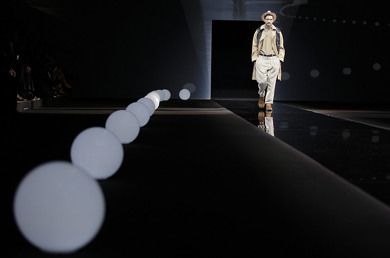 
              A model wears a creation part of the Giorgio Armani men's Spring-Summer 2016-2017 collection, that was presented in Milan, Italy, Tuesday, June 21, 2016. (AP Photo/Luca Bruno)
            