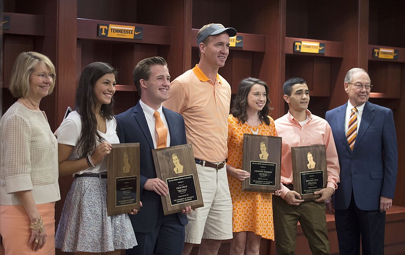 
              Retired NFL quarterback and Tennessee alumnus Peyton Manning, center, stands with four University of Tennessee students, who received scholarships awarded by his foundation Monday, June 20, 2016, in Knoxville, Tenn. From second from left are Andrea Ramirez, Chad Smith, Manning, Courtney Wombles and Benjamin Cruz.  (Amy Smotherman Burgess/Knoxville News Sentinel via AP)
            