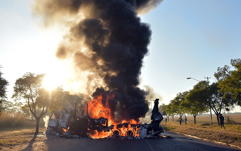 
              A vehicle burns as angry residents refused to accept the replacement of Pretoria's mayoral candidate in Atteridgeville, Pretoria, South Africa, Tuesday June 21, 2016. South African rioters blocked roads, looted shops and burned vehicles on Tuesday in several areas of the country's capital, Pretoria, in a show of anger over the selection of the ruling party's mayoral candidate ahead of local elections. The violence raised concerns about security ahead of the Aug. 3 elections in South Africa, where periodic unrest over the lack of basic municipal services already stretches police in many poor communities. In the past year, violence and vandalism have also hit some universities and other schools as students protest high fees and voice other grievances. (AP Photo)
            