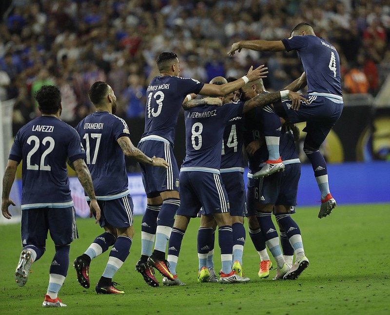 Argentina midfielder Lionel Messi is surrounded by teammates after scoring a goal against the United States during a Copa America Centenario semifinal soccer match Tuesday, June 21, 2016, in Houston.