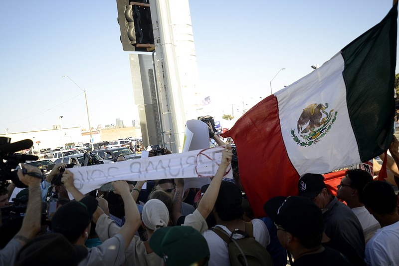 
              Protesters clash with Donald Trump supporters shortly after the a Donald Trump rally ended in Phoenix, Ariz., on Saturday, June 18, 2016. Several arguments sparked as the two groups crossed paths throughout the day, but city officials stepped in to disperse crowds if they became too heated. Trump railed Saturday against efforts by some frustrated Republicans planning a last-ditch effort to try to thwart him from becoming the party's nominee, threatening at one point to stop fundraising if Republicans don't rally around him. (AP Photo/Beatriz Costa-Lima)
            