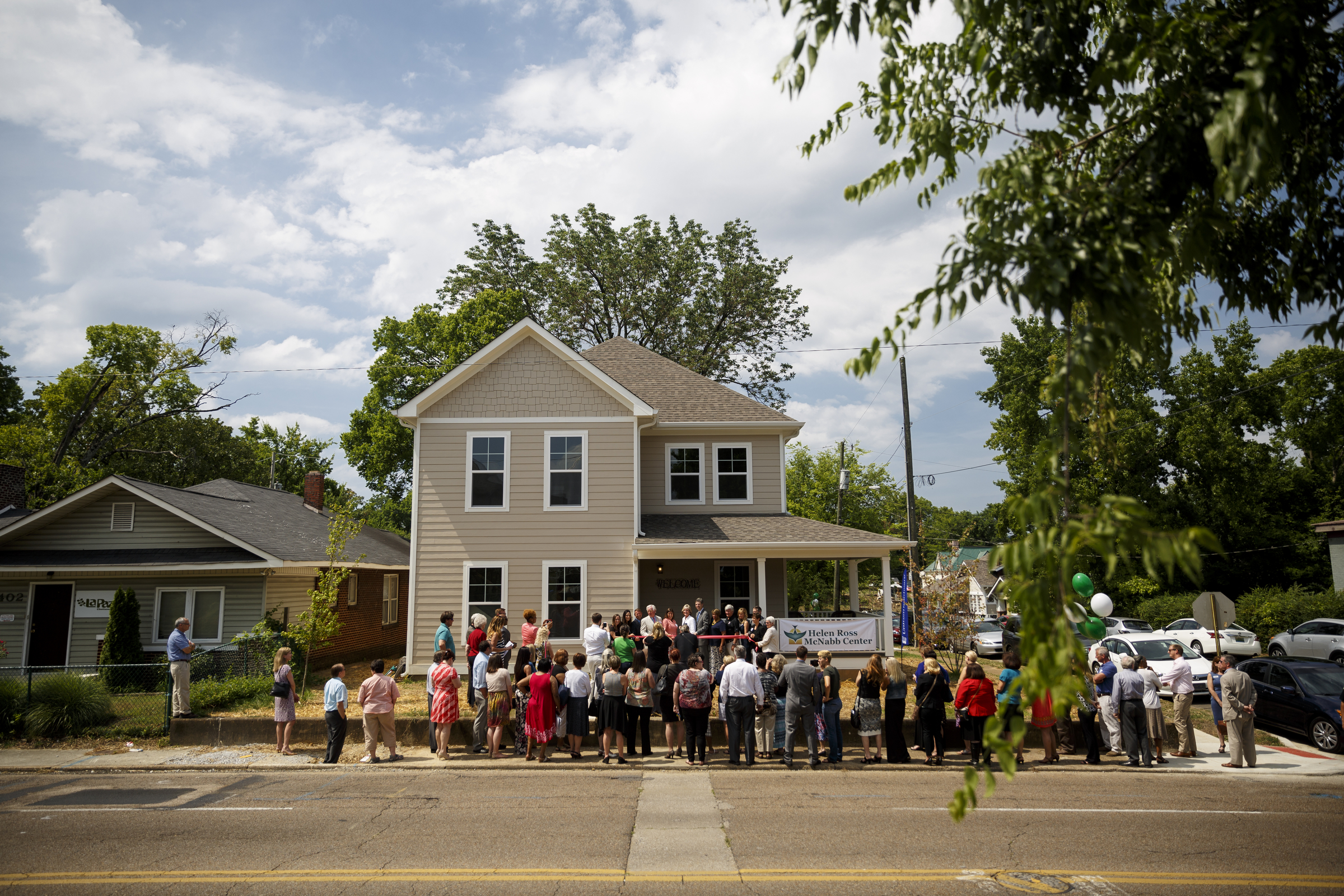 People gather at a ribbon-cutting for Bailey Home, a new residence facility for people with mental disabilities, on Tuesday, June 21, 2016, in Chattanooga, Tenn. The co-ed facility set up by Helen Ross McNabb Center will house 10 residents.